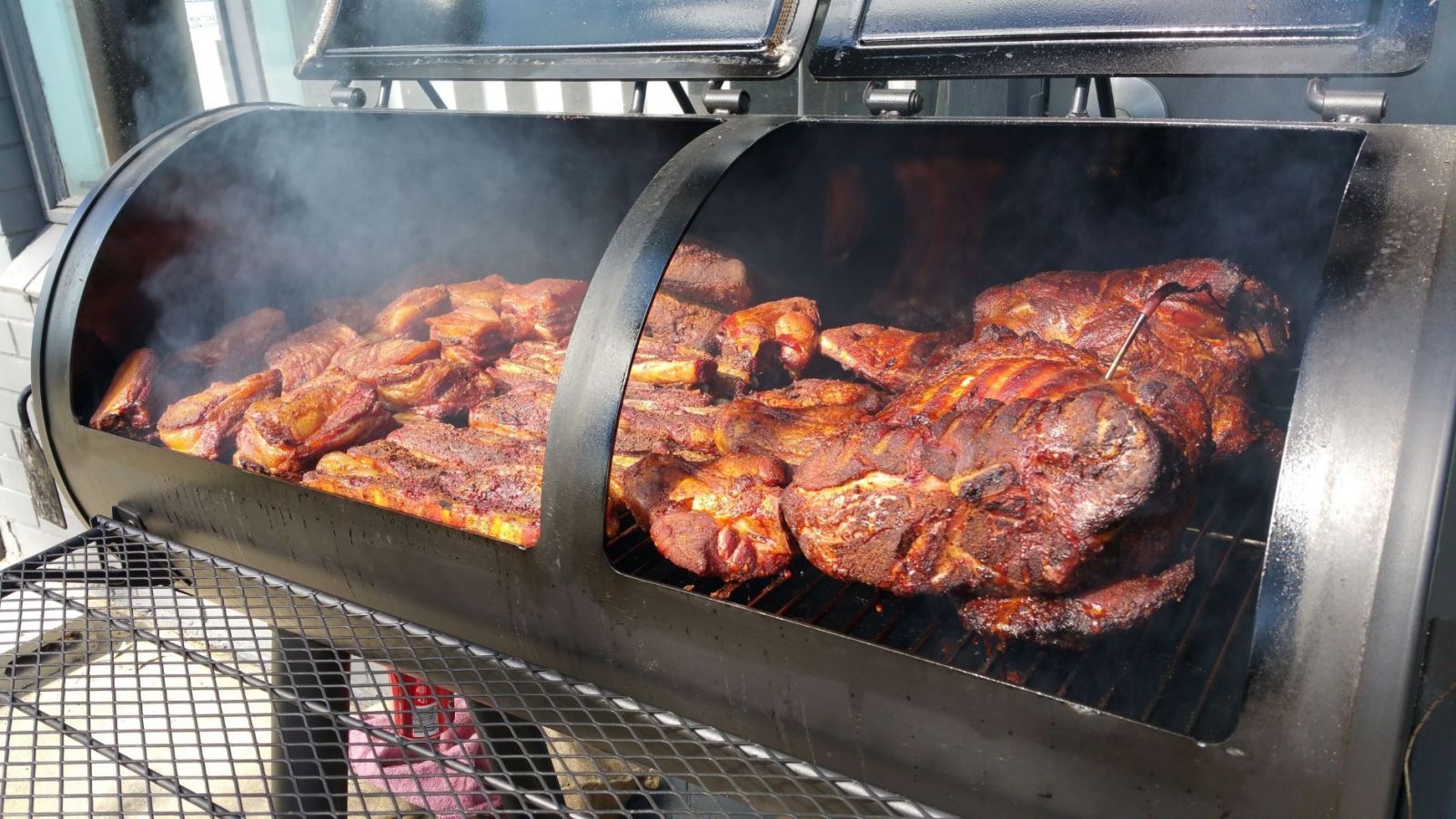 Image showing the offset smoker filled with different types of meat